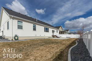 Back of property with a patio area, a fenced backyard, and a yard