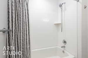 Full bathroom with shower / bath combo with shower curtain