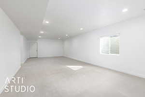 Empty room with recessed lighting, baseboards, and light colored carpet