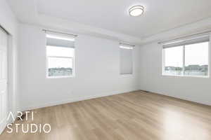 Empty room with light wood-style floors and baseboards