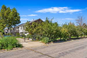 Exterior space featuring a gate, fence, and concrete driveway