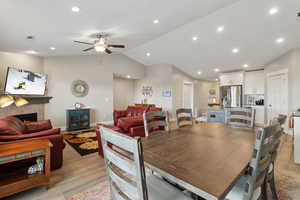 Dining room featuring visible vents, baseboards, lofted ceiling, light wood-type flooring, and recessed lighting