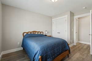 Bedroom featuring a closet, wood finished floors, and baseboards