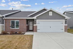 Ranch-style house with an attached garage, central air condition unit, brick siding, driveway, and roof with shingles