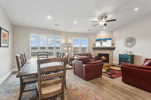 Living room featuring recessed lighting, visible vents, light wood-type flooring, baseboards, and a tile fireplace