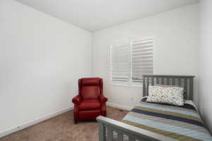 Carpeted bedroom with visible vents and baseboards