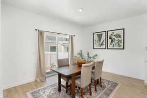 Dining space featuring light wood-style floors and baseboards