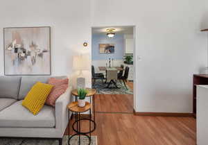 Living area with wood finished floors and baseboards