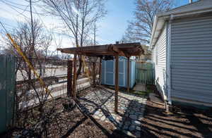 View of yard featuring a shed, a patio, a fenced backyard, and an outdoor structure