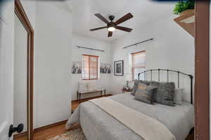 Bedroom with baseboards, a ceiling fan, and wood finished floors