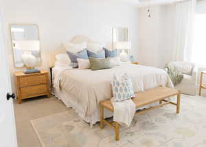 Bedroom featuring light colored carpet