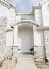 Entrance to property with stone siding
