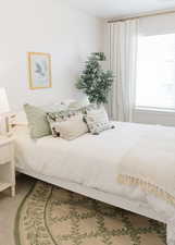 Carpeted bedroom featuring visible vents