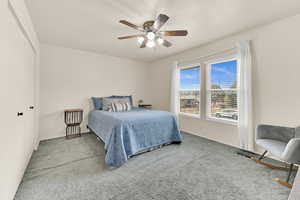 Carpeted bedroom with ceiling fan