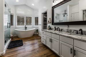 Primary en-suite bath with free-standing tub and quartzite countertops.