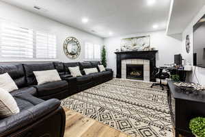 Lower level family room with inviting fireplace.