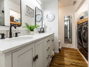 3/4 bath with double sinks and second laundry area.