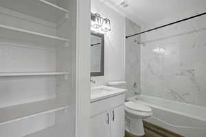 Full bath with toilet, wood finished floors, vanity, visible vents, and shower / washtub combination