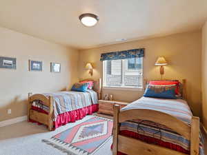 Bedroom with carpet, visible vents, and baseboards