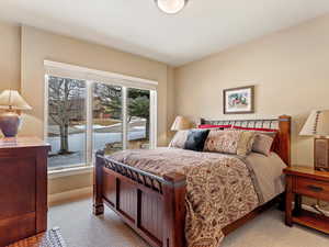 Bedroom featuring carpet floors and baseboards