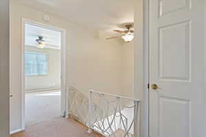 Hallway featuring carpet flooring and baseboards