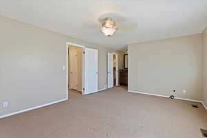 Unfurnished bedroom with carpet flooring, visible vents, and baseboards