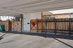 View of patio with fence and a gate