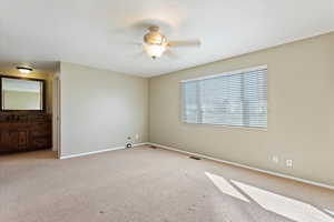 Unfurnished bedroom with light carpet, visible vents, a ceiling fan, and baseboards