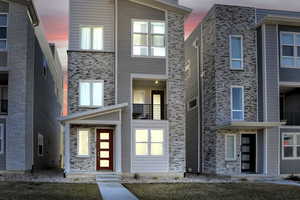 Contemporary home featuring stone siding