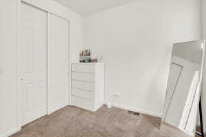 bedroom with carpet floors and a closet