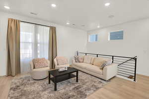 Living room featuring light wood-style floors, recessed lighting