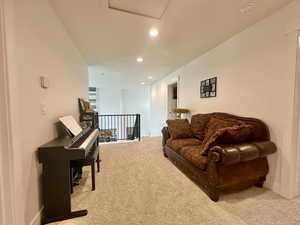 Living area featuring recessed lighting, baseboards, and carpet floors