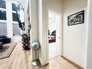 Corridor featuring baseboards and wood finished floors