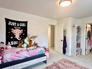 Carpeted bedroom featuring a textured ceiling