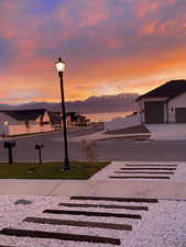 View of road with street lighting and a water and mountain view