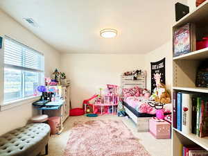 Carpeted bedroom featuring visible vents