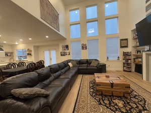 Living area with recessed lighting, light wood-type flooring, baseboards, and french doors