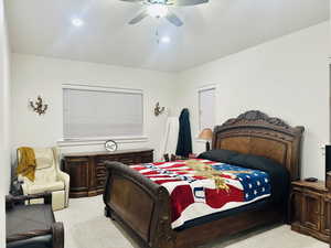 Bedroom featuring light colored carpet and a ceiling fan