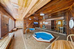 View of pool with an indoor in ground hot tub