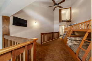 Bedroom with carpet floors and a high ceiling