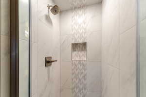 Interior details featuring a tile shower