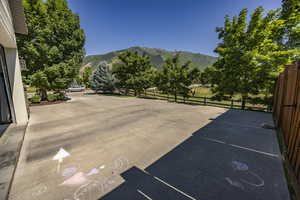 View of patio / terrace featuring a mountain view and fence