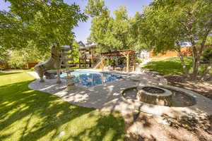 View of swimming pool with a patio, a water slide, a fenced backyard, a lawn, and a pergola