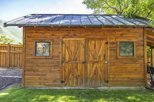 View of outdoor structure featuring an outdoor structure and fence