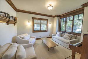 Living room with baseboards and light colored carpet