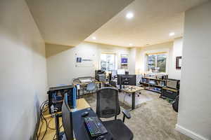 Carpeted home office with baseboards, a textured ceiling, and recessed lighting