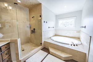 Bathroom with a garden tub, recessed lighting, a shower stall, and tile patterned floors