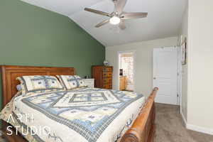 Bedroom with carpet floors, ensuite bathroom, a ceiling fan, vaulted ceiling, and baseboards