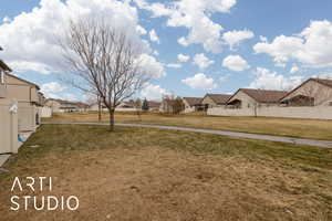 View of yard featuring a residential view and fence