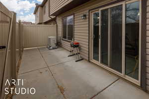 View of patio / terrace with ac unit, fence, and area for grilling